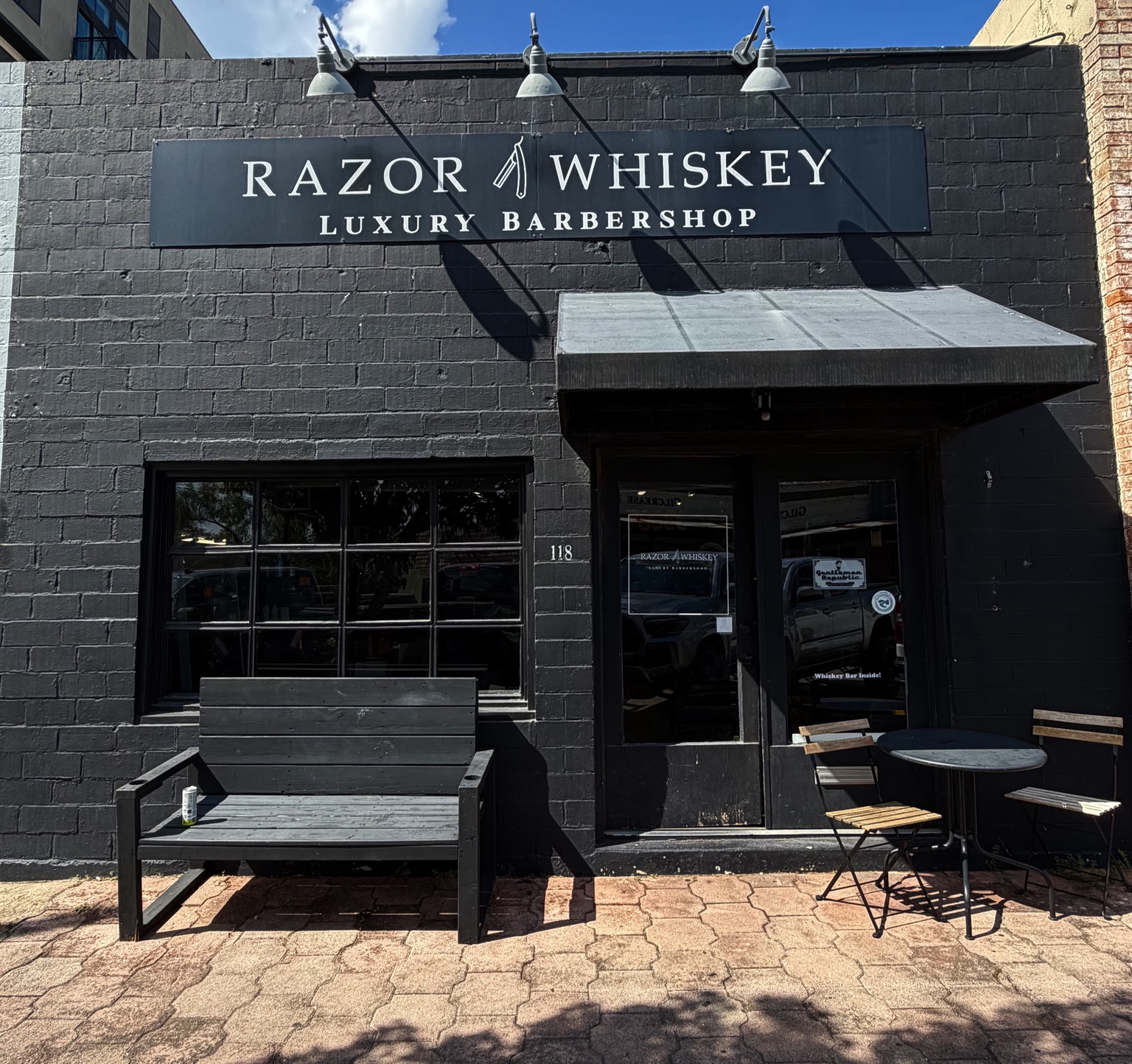 Actual storefront of Razor & Whiskey Luxury Barbershop at 118 W San Antonio Street in San Marcos, Texas